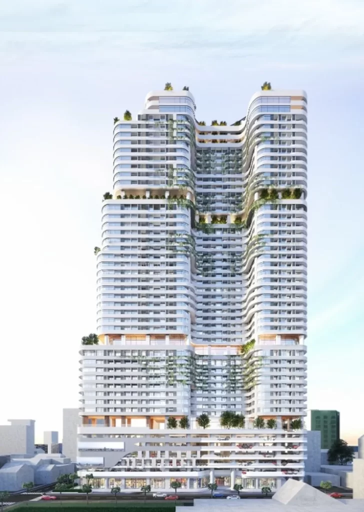 A modern, high-rise building with curved, tiered layers and a white exterior, featuring multiple green rooftop terraces and large windows—an ideal setting for a stylish studio apartment for city living against a backdrop of blue sky.