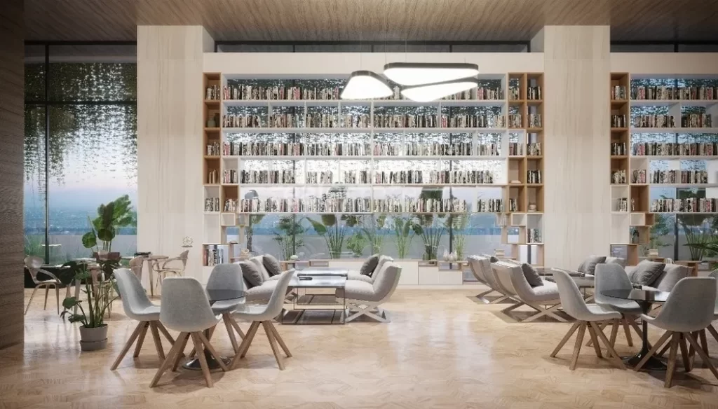 Modern library lounge perfect for a studio apartment, featuring floor-to-ceiling bookshelves, gray chairs around wooden tables, large windows, indoor plants, and ample natural light creating a cozy and inviting atmosphere.