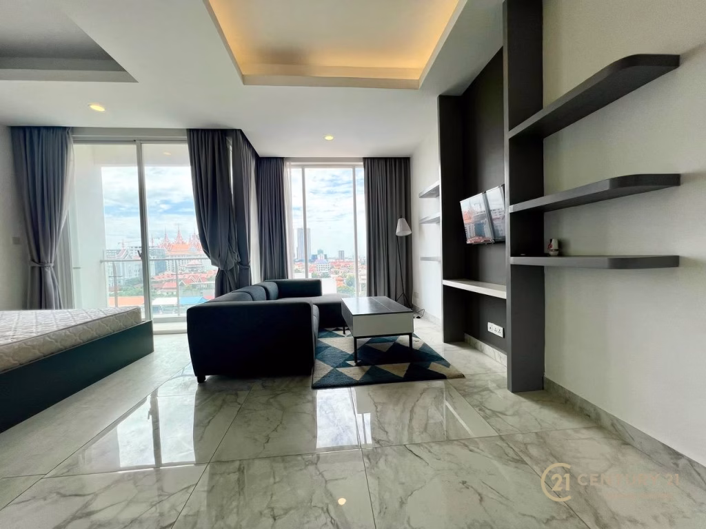 A studio apartment for rent featuring a cozy living room with a couch and a coffee table.
